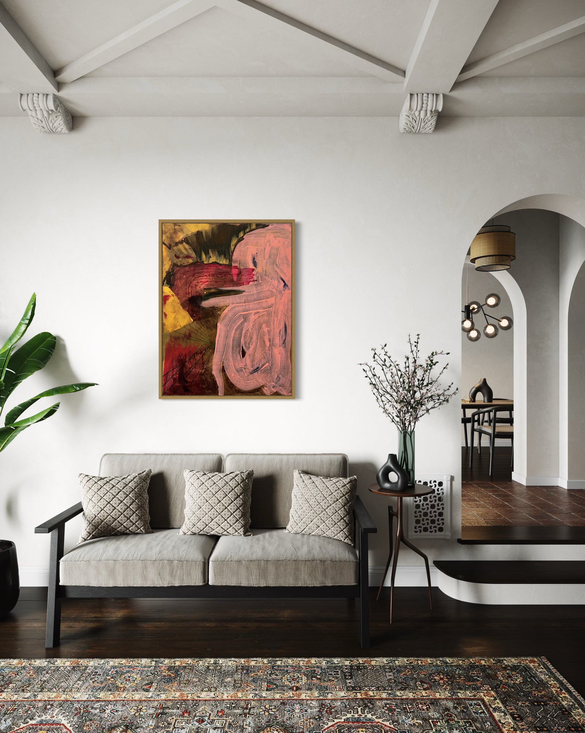 Living room with a gray sofa, abstract painting, and decorative elements.